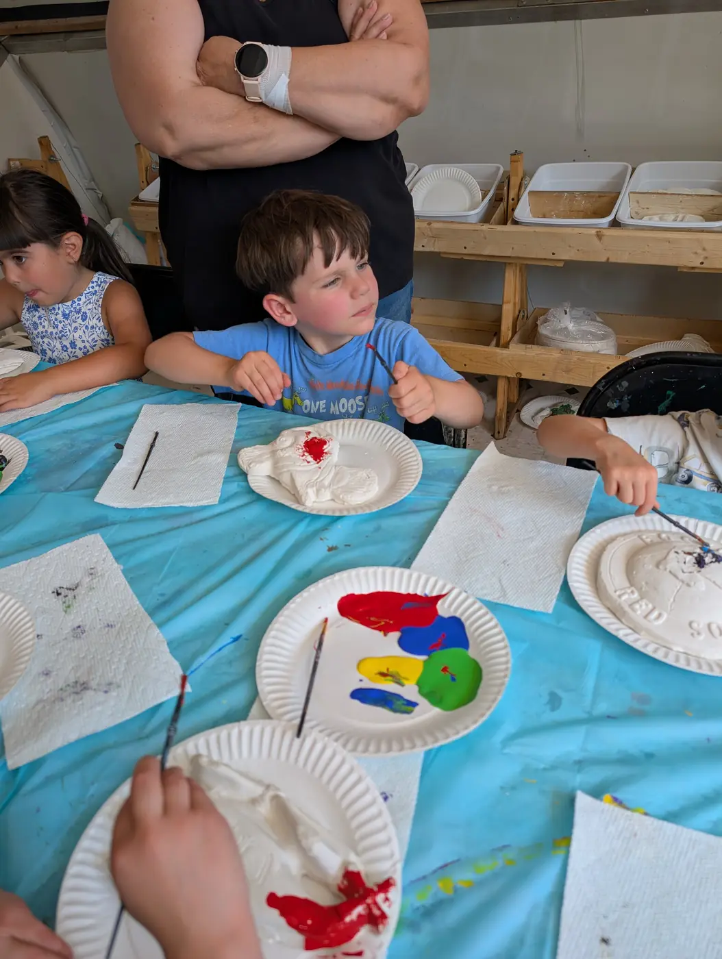 Preschoolers working together at an art and painting table at Blossom Station