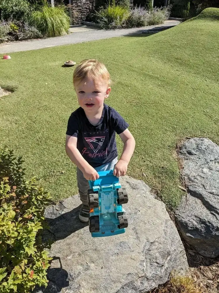 A child playing outdoors on the Blossom Station playground